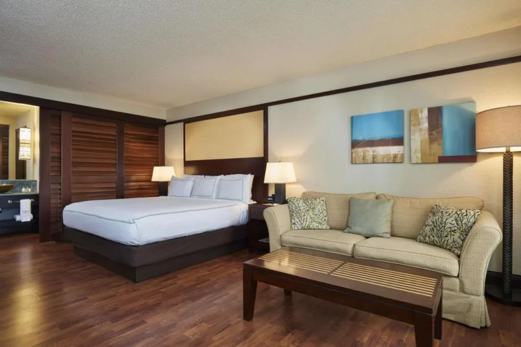 King room with sofa and coffee table at the DoubleTree by Hilton Orlando Theme Park Resort