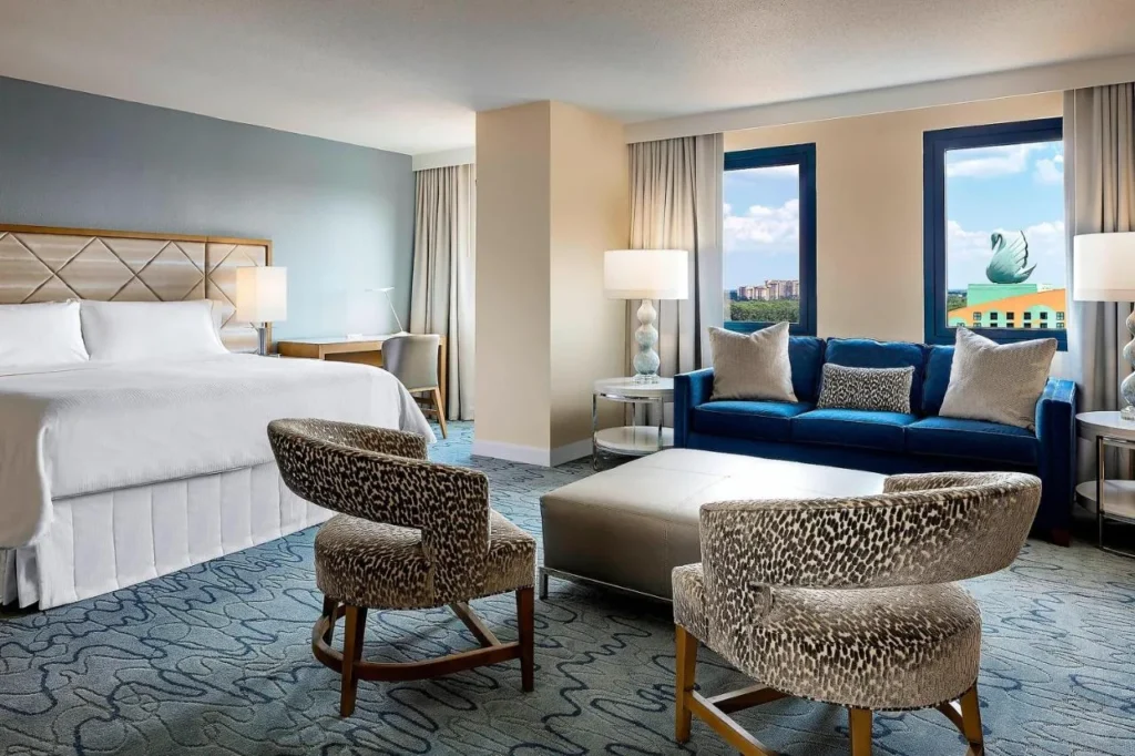 King room with sofa and windows facing the Swan's rooftop statue at Walt Disney World Dolphin