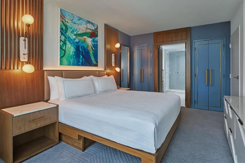 King room with swimmer artwork and blue wardrobes at Walt Disney World Swan Reserve