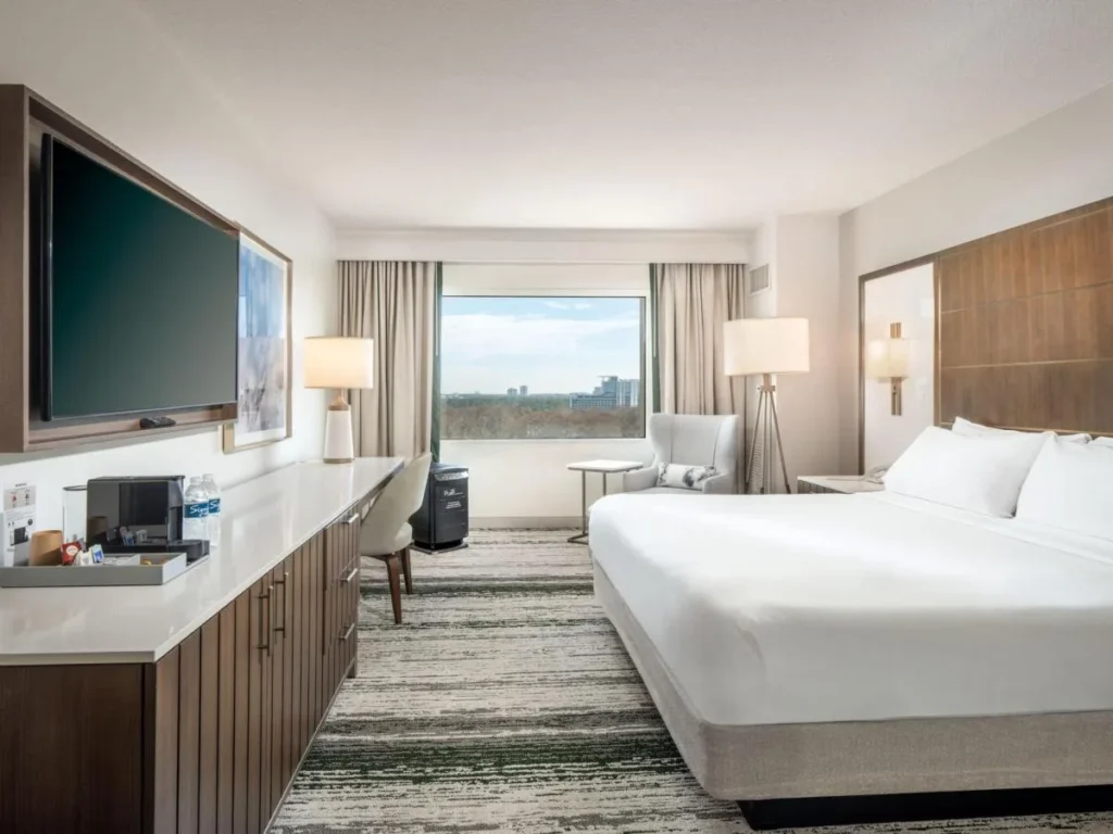 King room with wall TV and long dresser at Signia by Hilton Orlando Bonnet Creek