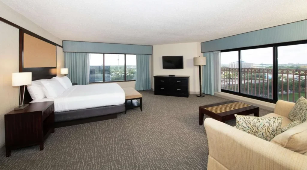 King suite with corner windows and a high-floor balcony at the DoubleTree Orlando Theme Park Resort