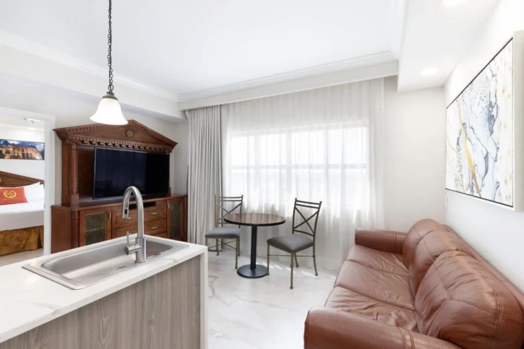 Kitchen island, leather sofa and bistro table in a two-bedroom suite at Westgate Palace