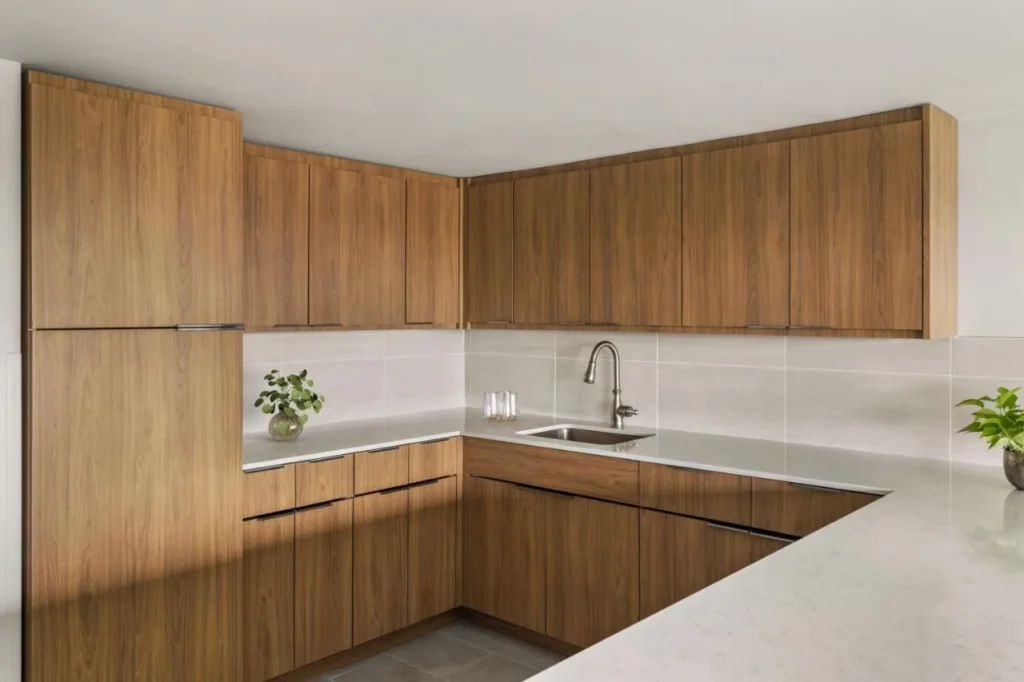 Kitchenette with wood cabinets and stone counters at Delta Hotels Orlando Celebration