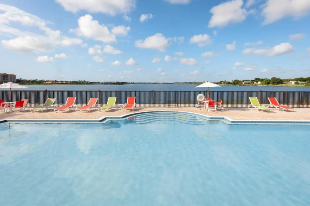 Lakefront swimming pool with colorful loungers at Westgate Lakes Resort and Spa