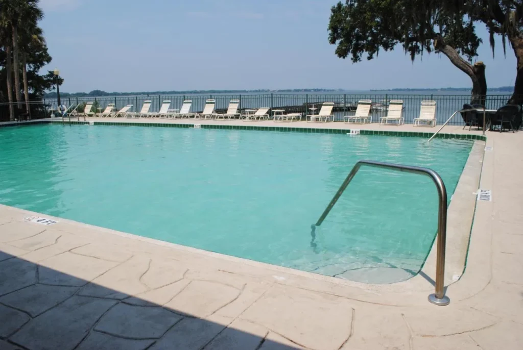 Lakefront swimming pool with loungers overlooking Lake Dora at the Lakeside Inn