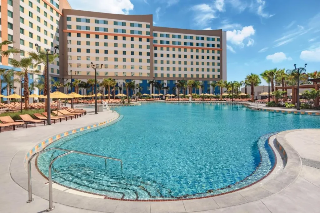 Large curved pool with loungers and umbrellas at Endless Summer Resort Dockside Inn and Suites
