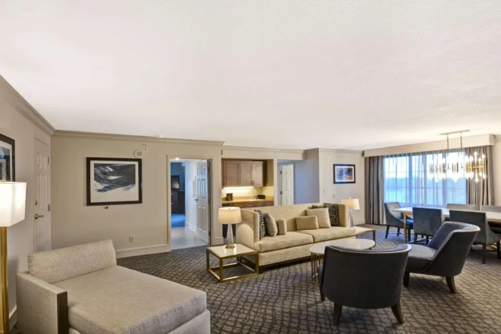 Large suite living and dining room with sofas at Embassy Suites Orlando Downtown