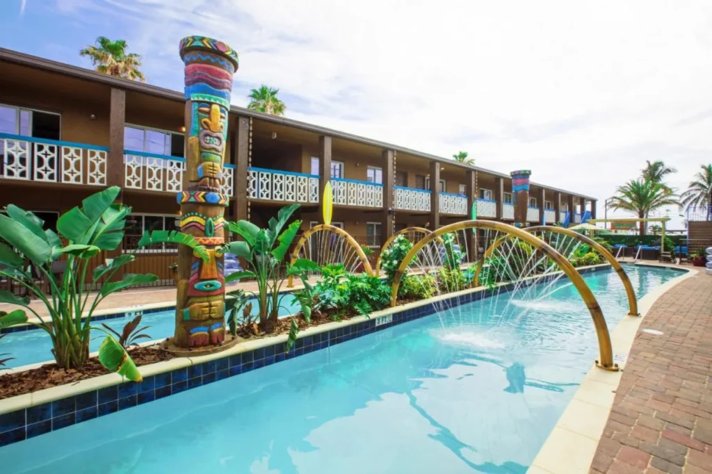 Lazy river with water arches and a carved tiki totem at Westgate Cocoa Beach Resort