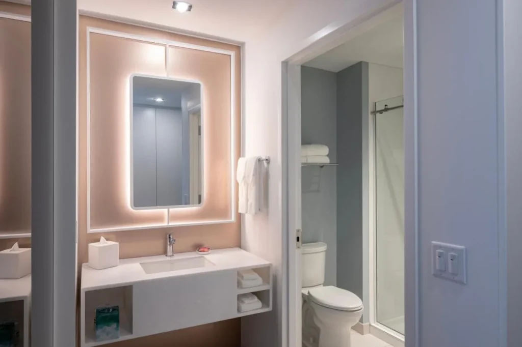 Lit vanity mirror and a separate shower and toilet room at Universal Stella Nova Resort