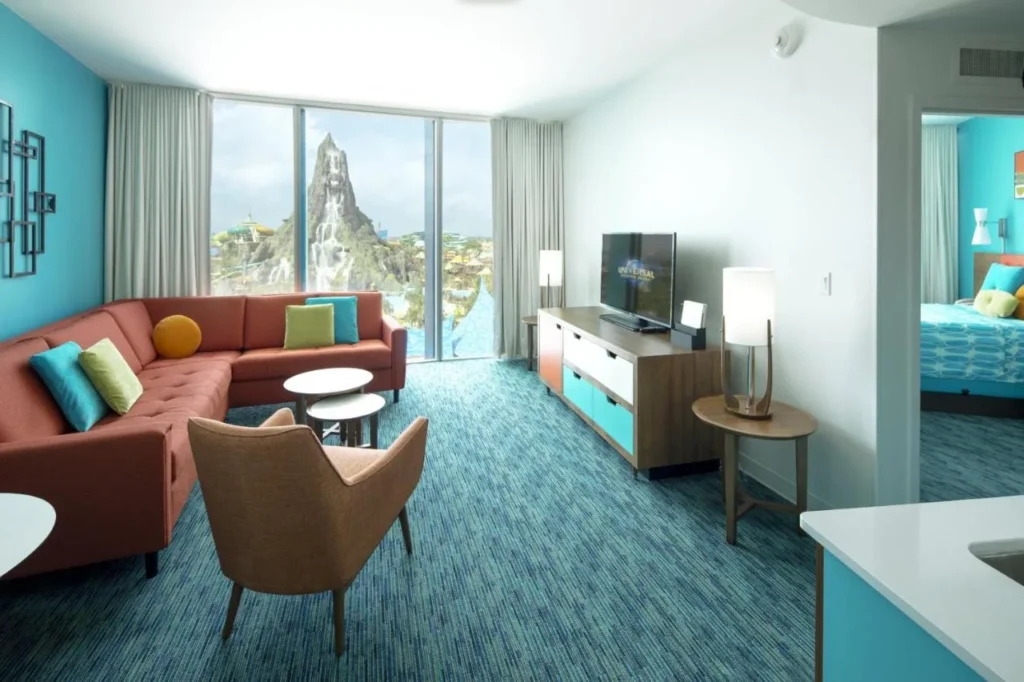 Living area with sectional sofa and Volcano Bay view in a Cabana Bay 2-Bedroom Suite