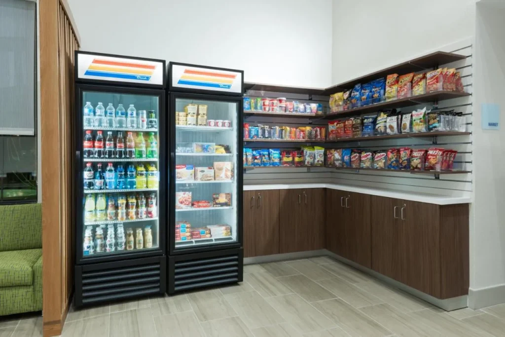 Lobby market with drinks fridges and snack shelves at Holiday Inn Express Nearest Universal Orlando