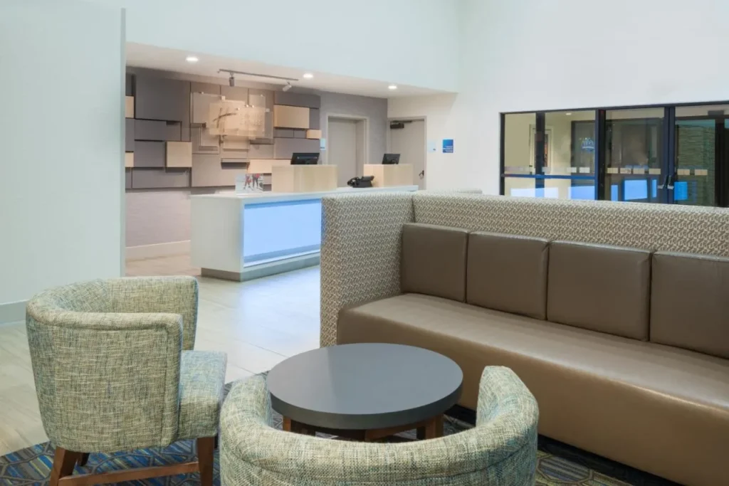 Lobby seating area and front desk at Holiday Inn Express Nearest Universal Orlando
