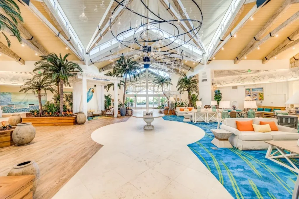 Lobby with palm trees, a chandelier and blue carpet at Margaritaville Resort Orlando