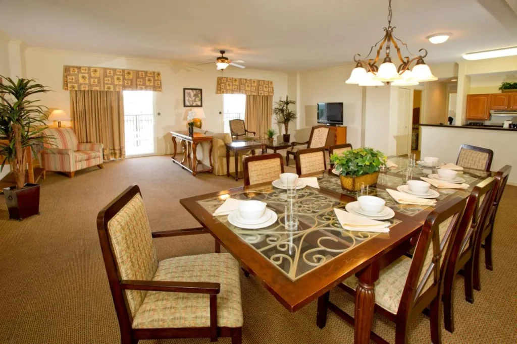 Long dining table and living area in a large suite at Lake Buena Vista Resort Village