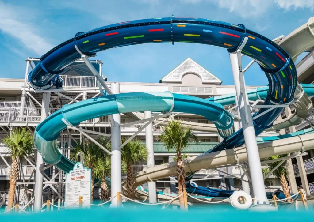 Looping Triple Tide Tower slides above the surf pool at Holiday Inn Resort Orlando Suites