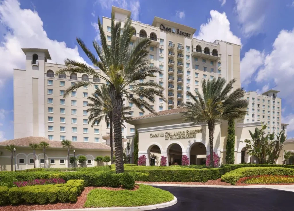 Main entrance and tower of Omni Orlando Resort at ChampionsGate with palm trees and gardens