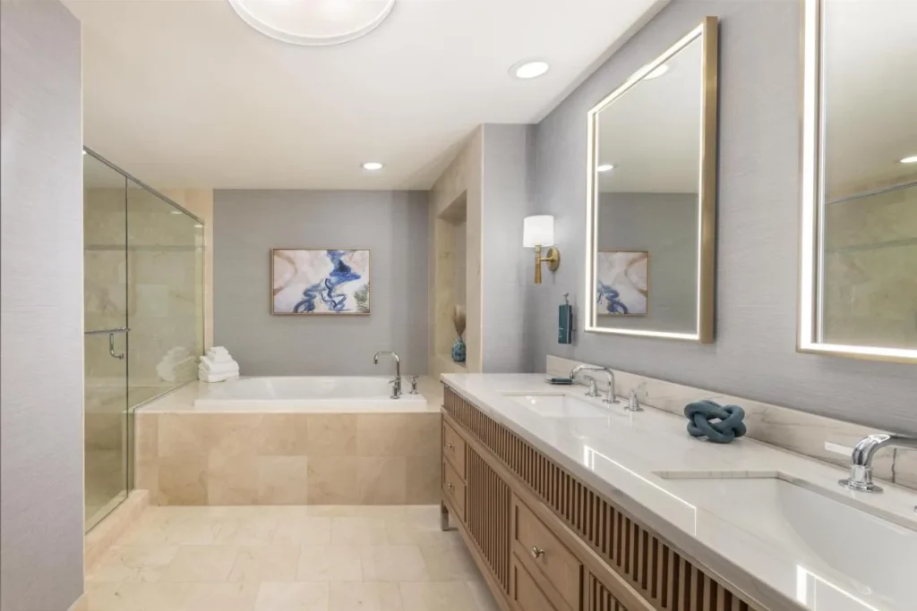 Marble bathroom with a soaking tub, glass shower and double vanity at Hilton Orlando