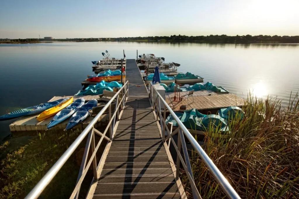Marina dock with paddle boats, kayaks and pontoons at Westgate Lakes Resort and Spa
