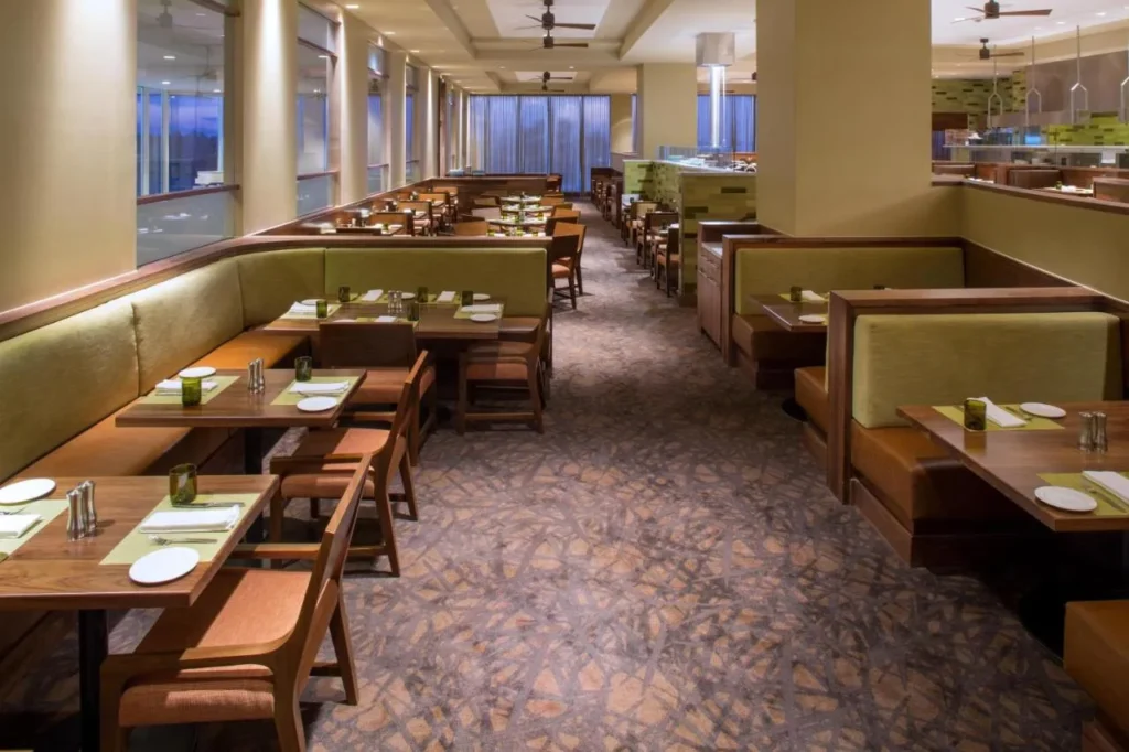 McCoy's Bar and Grill green booths beside tall windows at Hyatt Regency Orlando International Airport