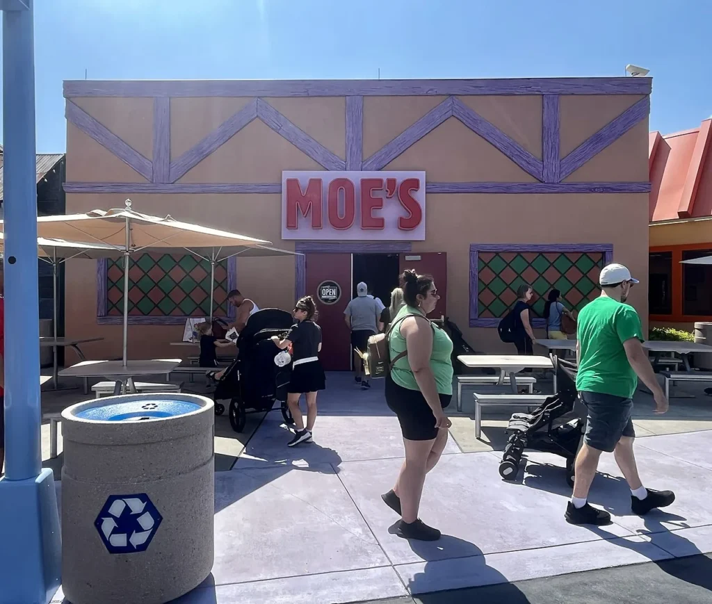 Moe's Tavern storefront with outdoor tables and strollers in Springfield, Universal Studios Florida