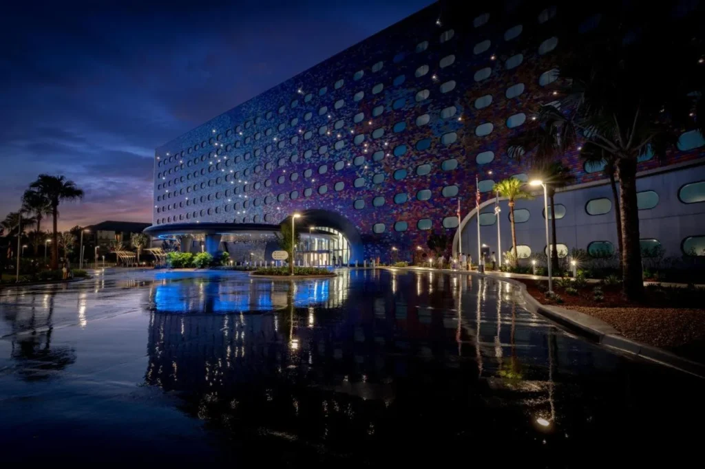 Mosaic facade with oval windows lit up at dusk at Universal Stella Nova Resort