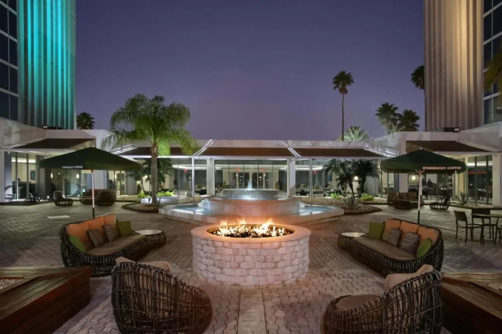 Night courtyard fire pit and fountain between hotel towers, DoubleTree at the Entrance to Universal