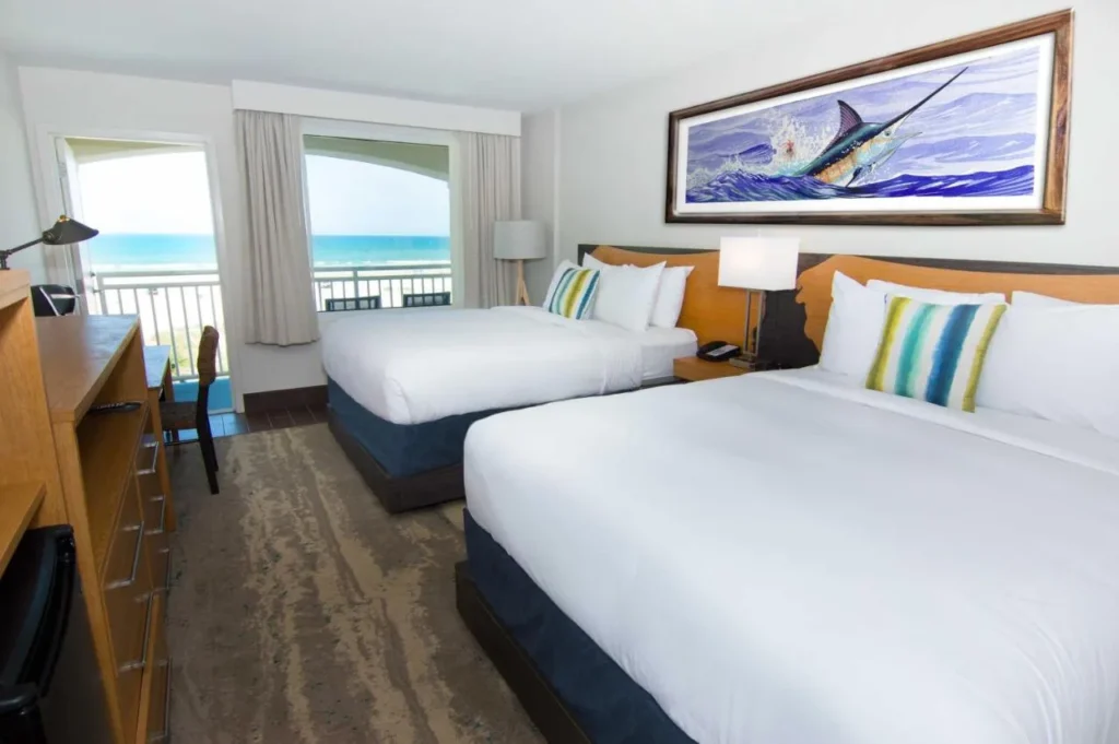 Ocean-view room with two queen beds and marlin art at Guy Harvey Resort St. Augustine Beach