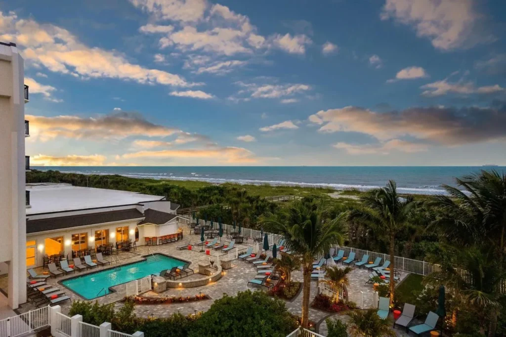 Oceanfront pool deck and dunes at sunset at Hilton Garden Inn Cocoa Beach Oceanfront
