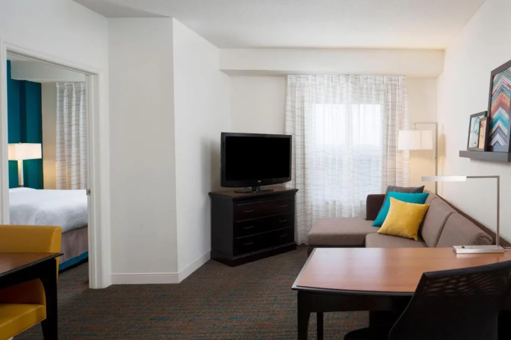 Suite de un dormitorio con sofá, TV y escritorio al lado del dormitorio, Residence Inn SeaWorld