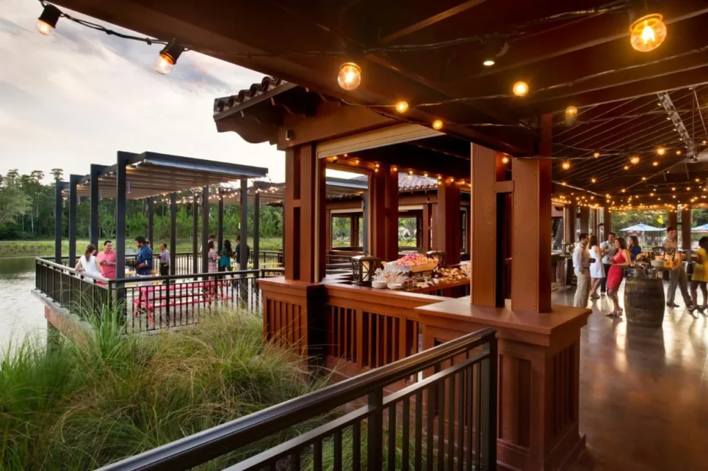 Open-air lakeside dining pavilion with string lights at Four Seasons Resort Orlando