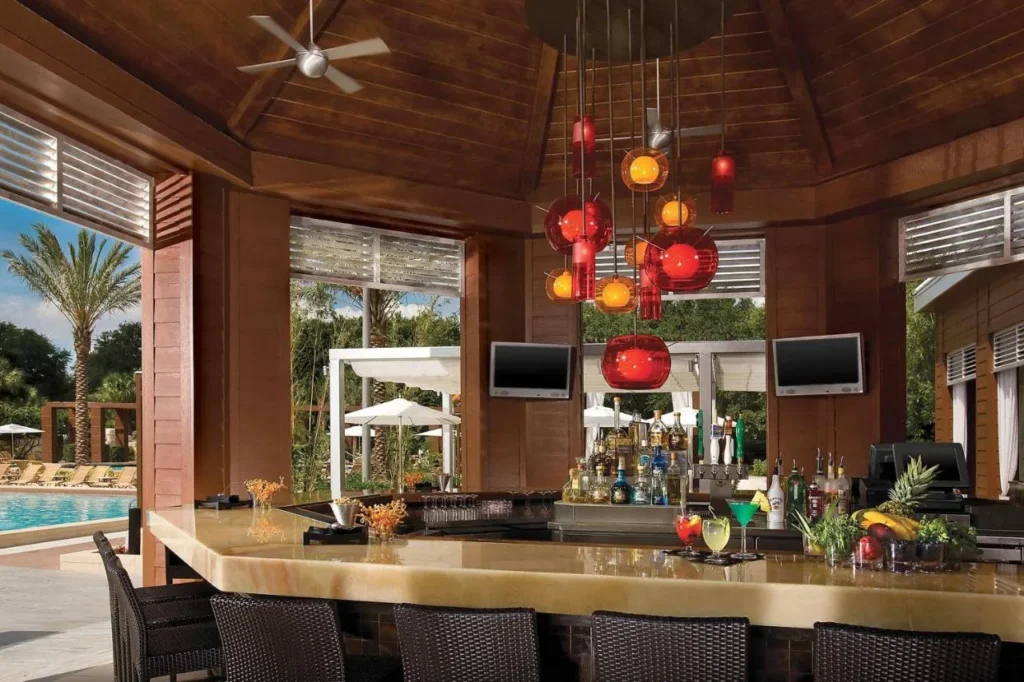 Open-air pool bar with red pendant lights at the Walt Disney World Dolphin