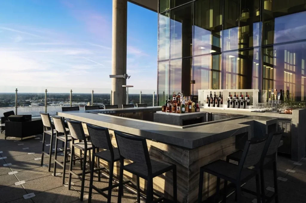 Open-air rooftop bar with high stools and wide city views at AC Hotel Orlando Downtown