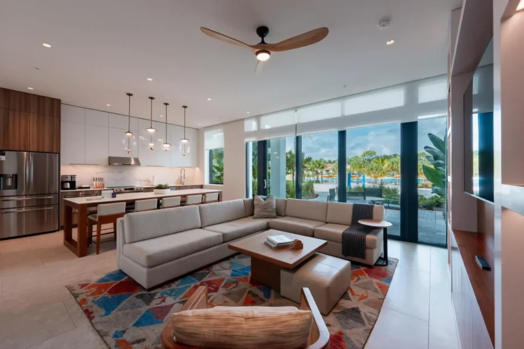 Open-plan living room and kitchen with a sectional sofa at Evermore Orlando Resort
