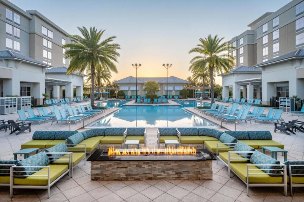 Outdoor pool and fire pit lounge at TownePlace Suites Orlando at Flamingo Crossings