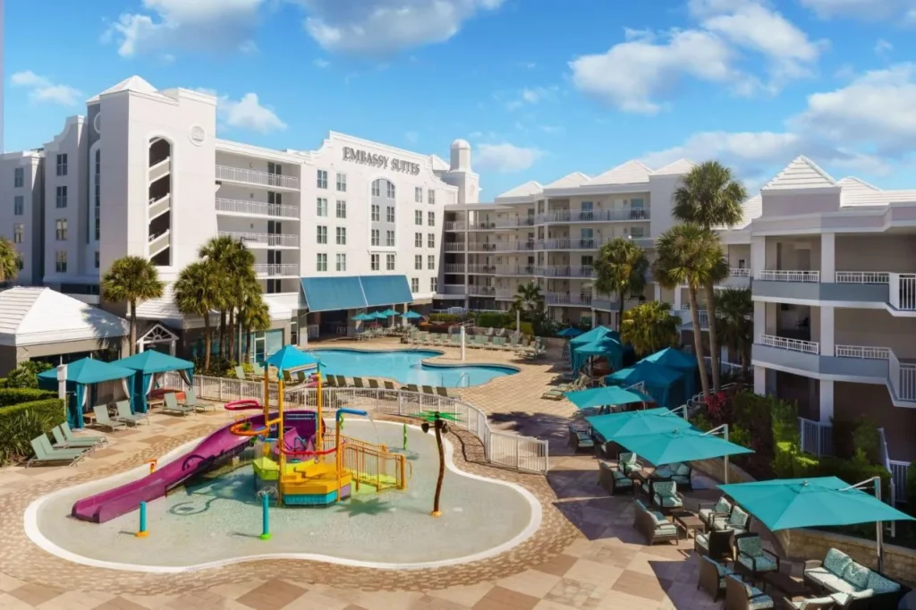 Outdoor pool, kids splash area and cabanas at Embassy Suites Orlando Lake Buena Vista Resort