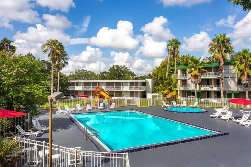 Outdoor pool, round kids' pool and playground at Baymont by Wyndham Orlando Lake Buena Vista South