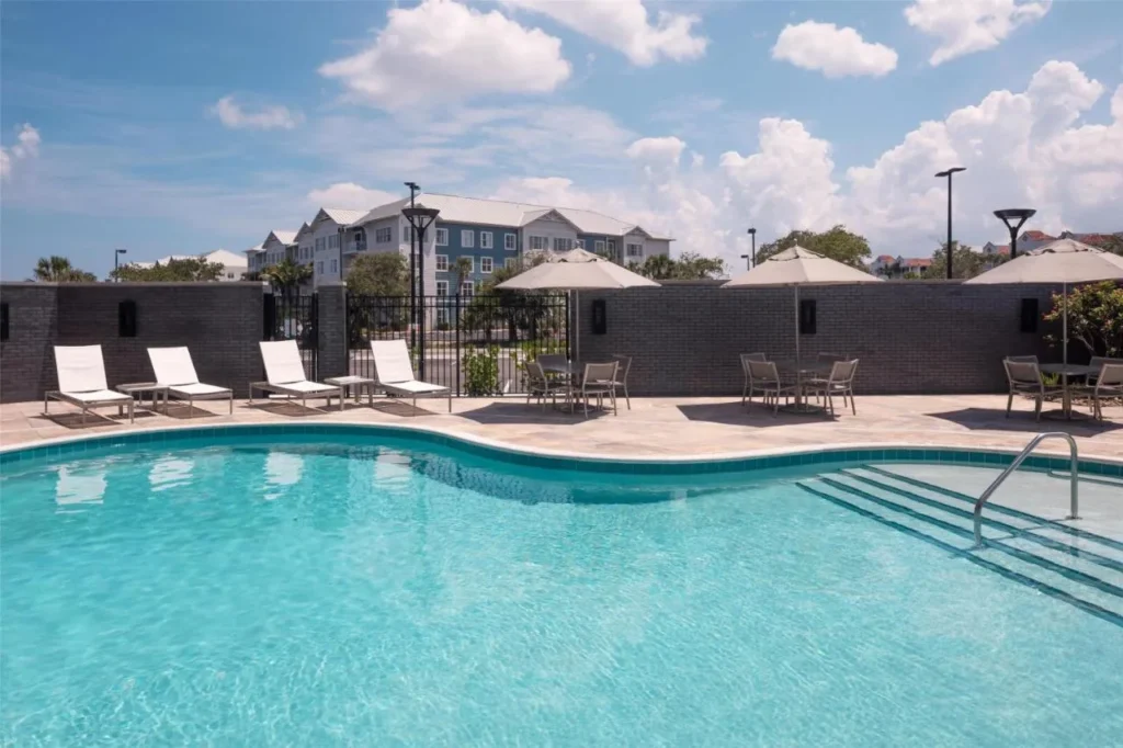 Outdoor pool with lounge chairs and umbrellas at Hyatt Place Cape Canaveral