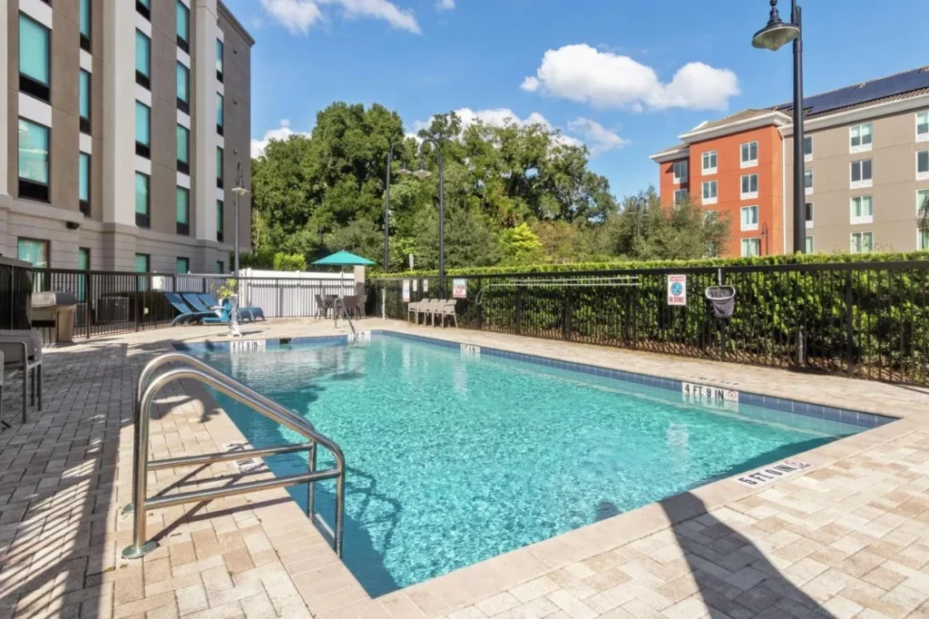 Outdoor pool with paver deck and lounge chairs at Hampton Inn & Suites Orlando-Apopka