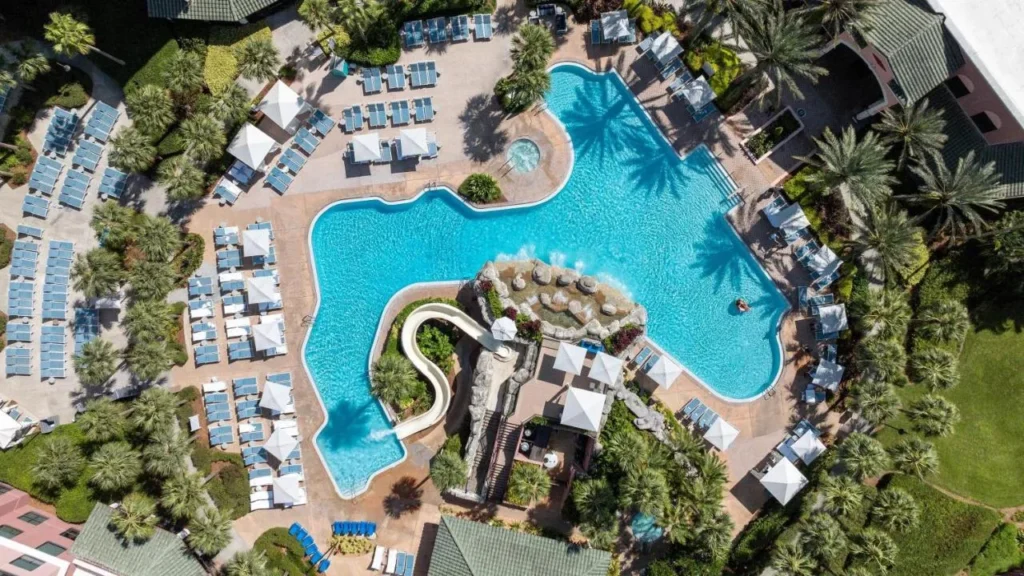Overhead view of the free-form pool, curving waterslide and cabanas at Caribe Royale Orlando