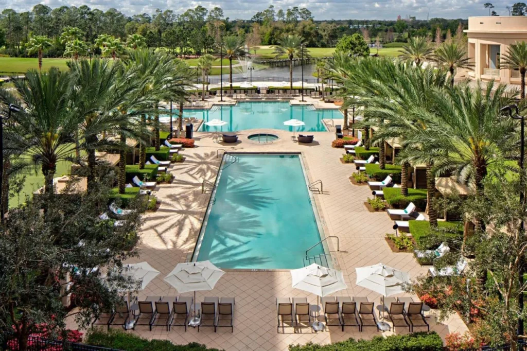 Overhead view of the Waldorf Astoria Orlando pool deck, lap pool, hot tub and loungers