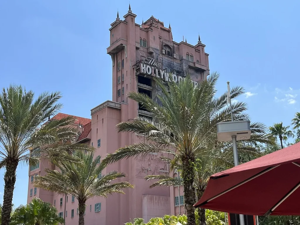 Pink Hollywood Tower Hotel of The Twilight Zone Tower of Terror behind palms, Hollywood Studios
