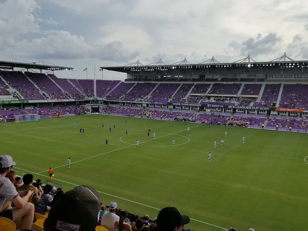 Players lined up for kickoff on the pitch at purple-seated Inter.co Stadium in downtown Orlando