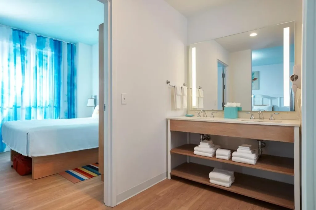 Queen bedroom doorway beside a double-sink vanity area at Surfside Inn and Suites