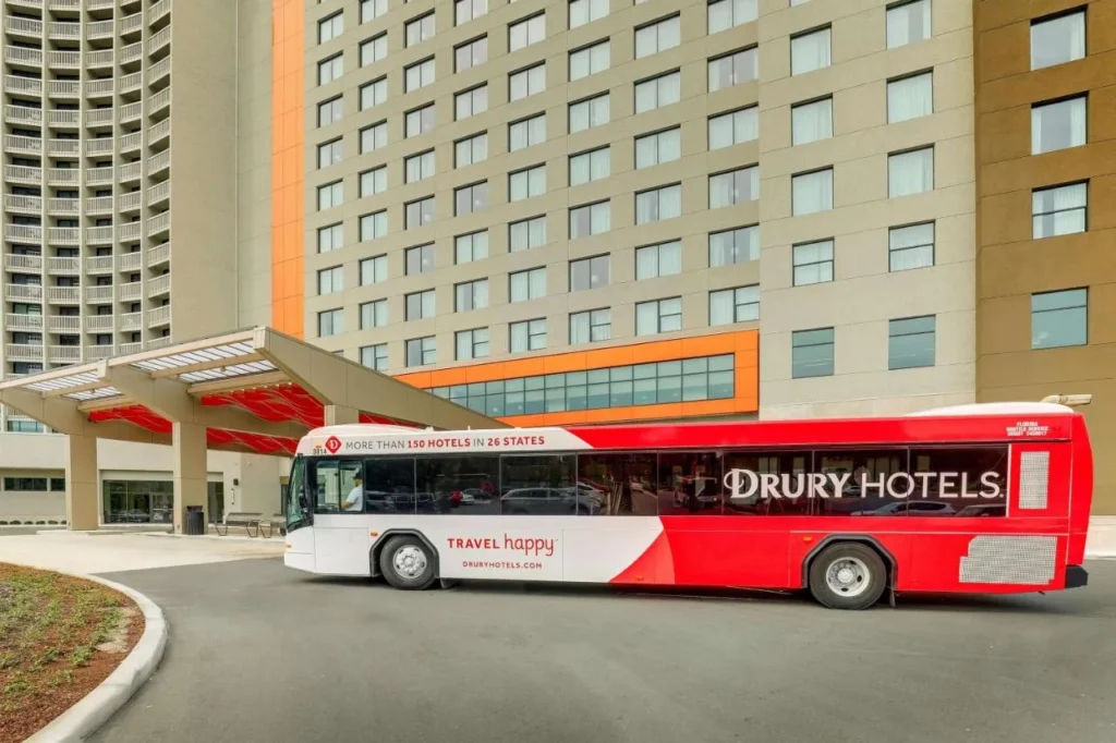 Autobús de enlace de Red Drury Hotels junto al dosel de la entrada principal en Drury Plaza Hotel Orlando