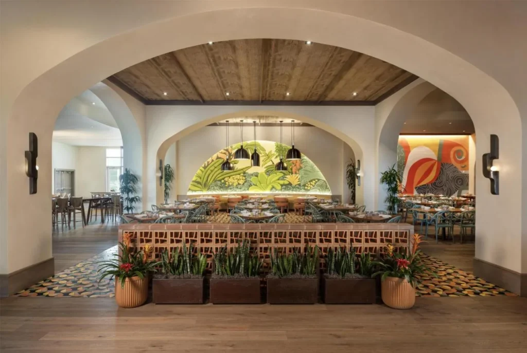 Restaurant with arched doorways, a jungle mural and colorful tiled floors at Hilton Orlando