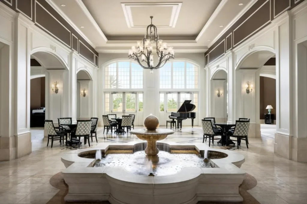 Reunion Grande lobby with a central fountain, chandelier and grand piano at Reunion Resort