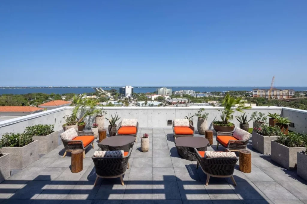 Rooftop terrace lounge chairs with views over downtown Melbourne and the Indian River at Hotel Melby