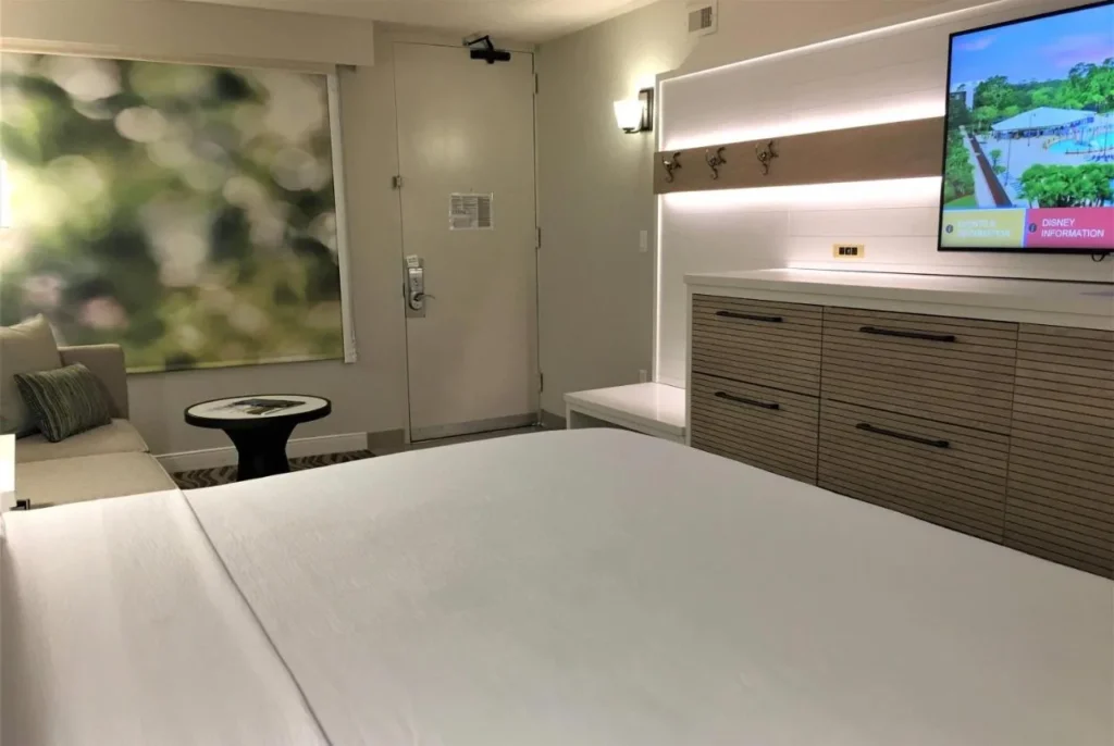 Room with a large bed, sofa, dresser and TV at Wyndham Garden Lake Buena Vista