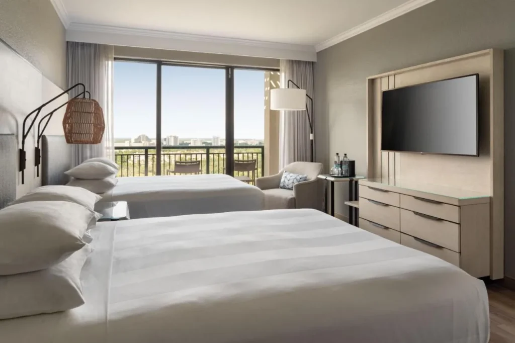 Room with two beds, a balcony and a treetop view at Orlando World Center Marriott