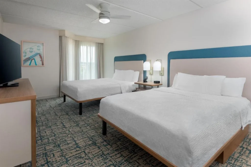 Room with two beds, a ceiling fan and TV at Homewood Suites Nearest to Universal Studios
